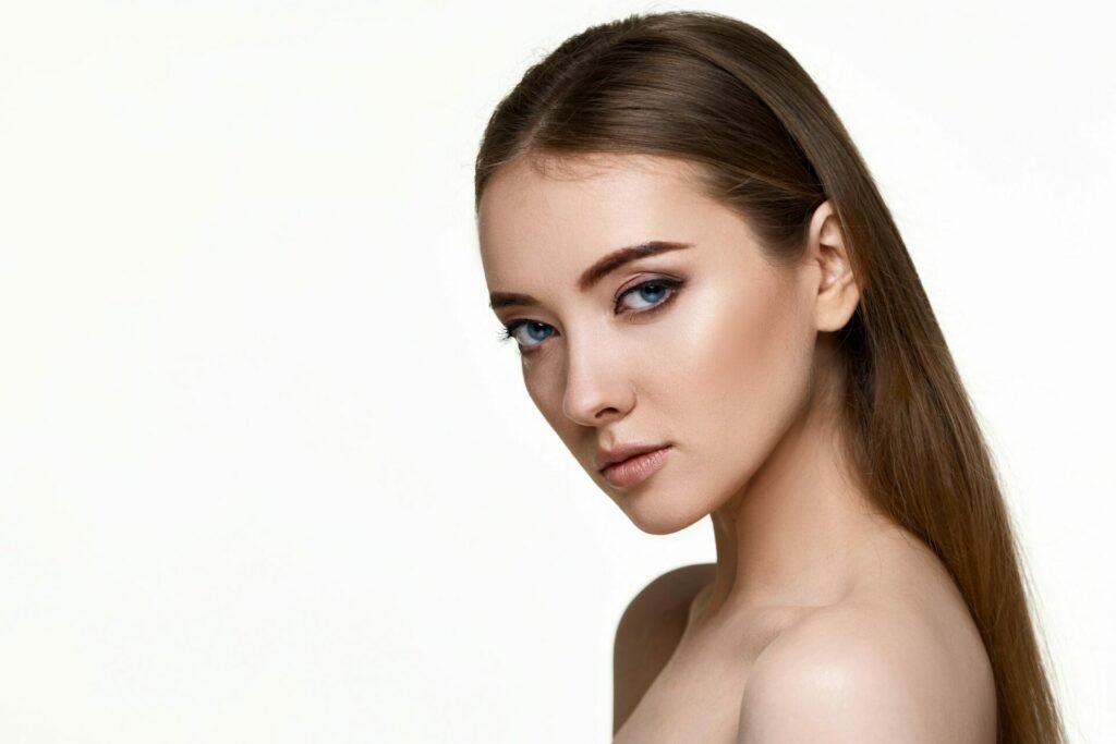 young woman with perfect skin on white background.